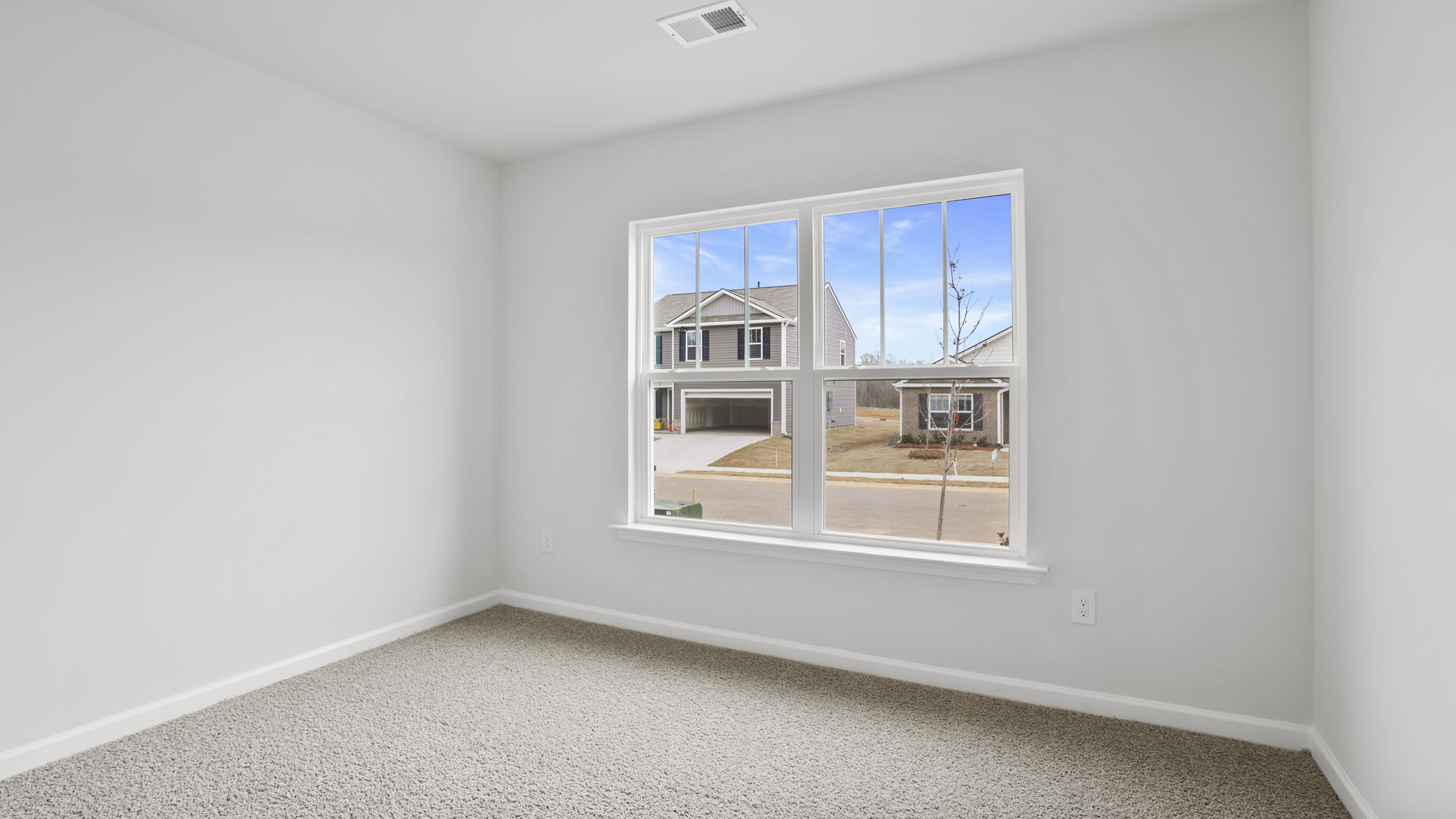 Bedroom with carpet and windows.