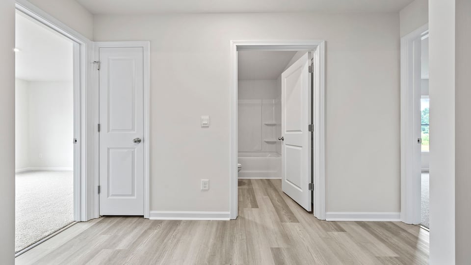 View of hallway and entrances to both bedrooms and hall bathroom.
