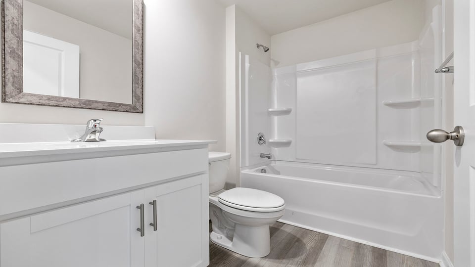 Hall bathroom with vanity and combination shower / tub.