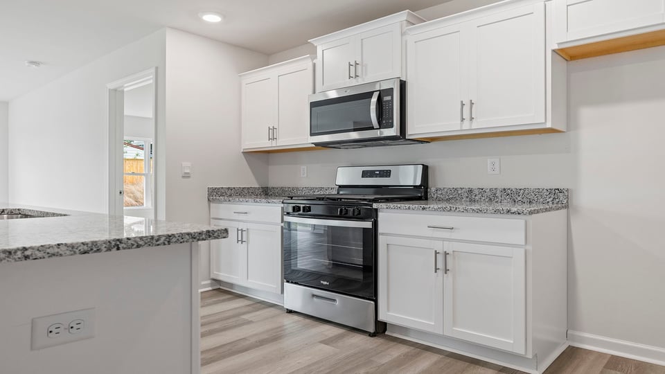 Kitchen features stainless steel appliances.