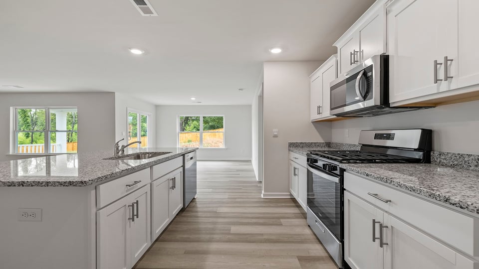 Kitchen and island have quartz countertops.