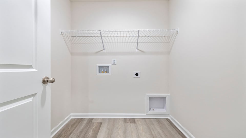 Walk-in laundry room with shelving.