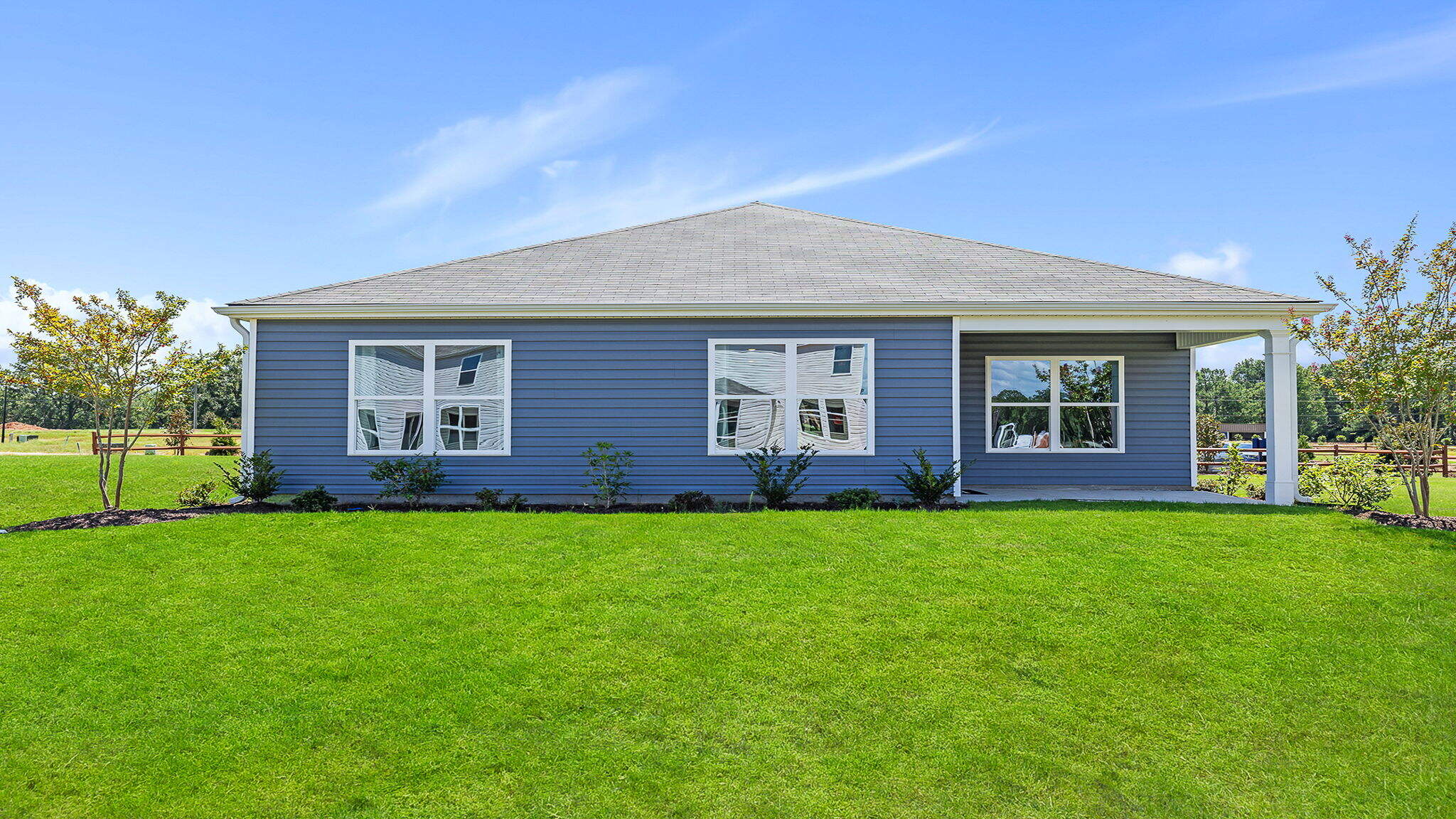 Back exterior with covered patio.