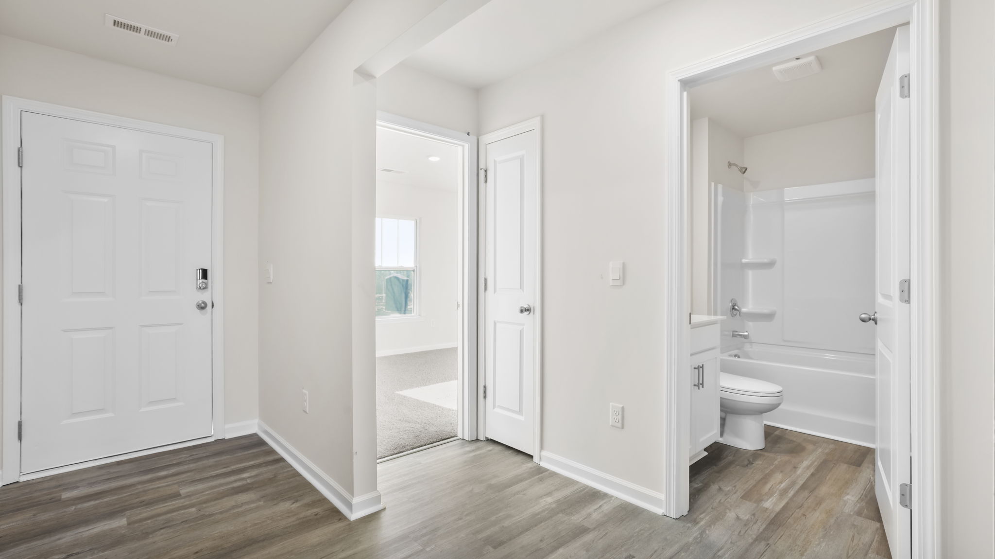 Entrance and view of front bedroom and hall bathroom.