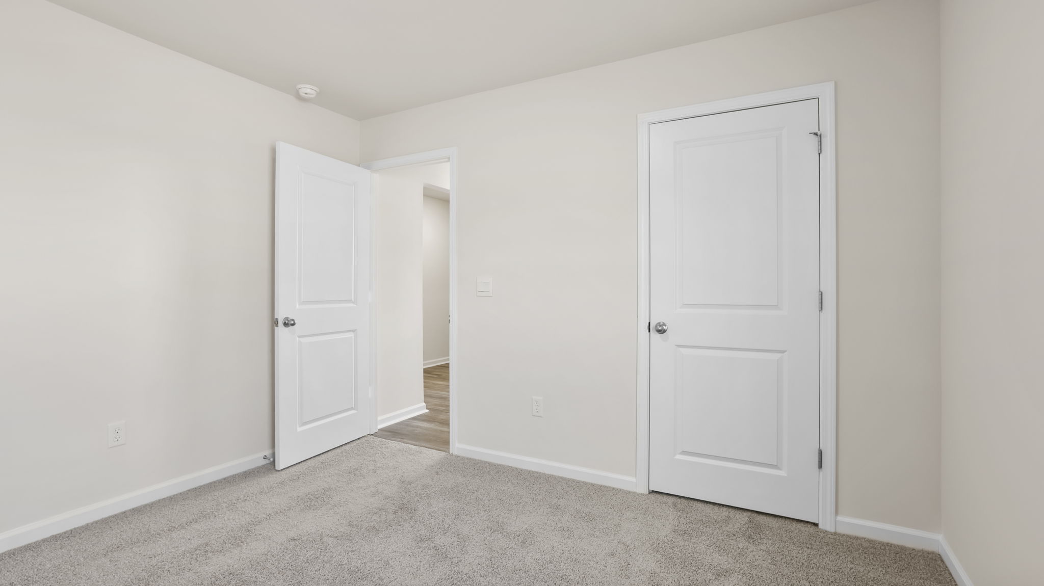 Bedroom with carpet and windows.