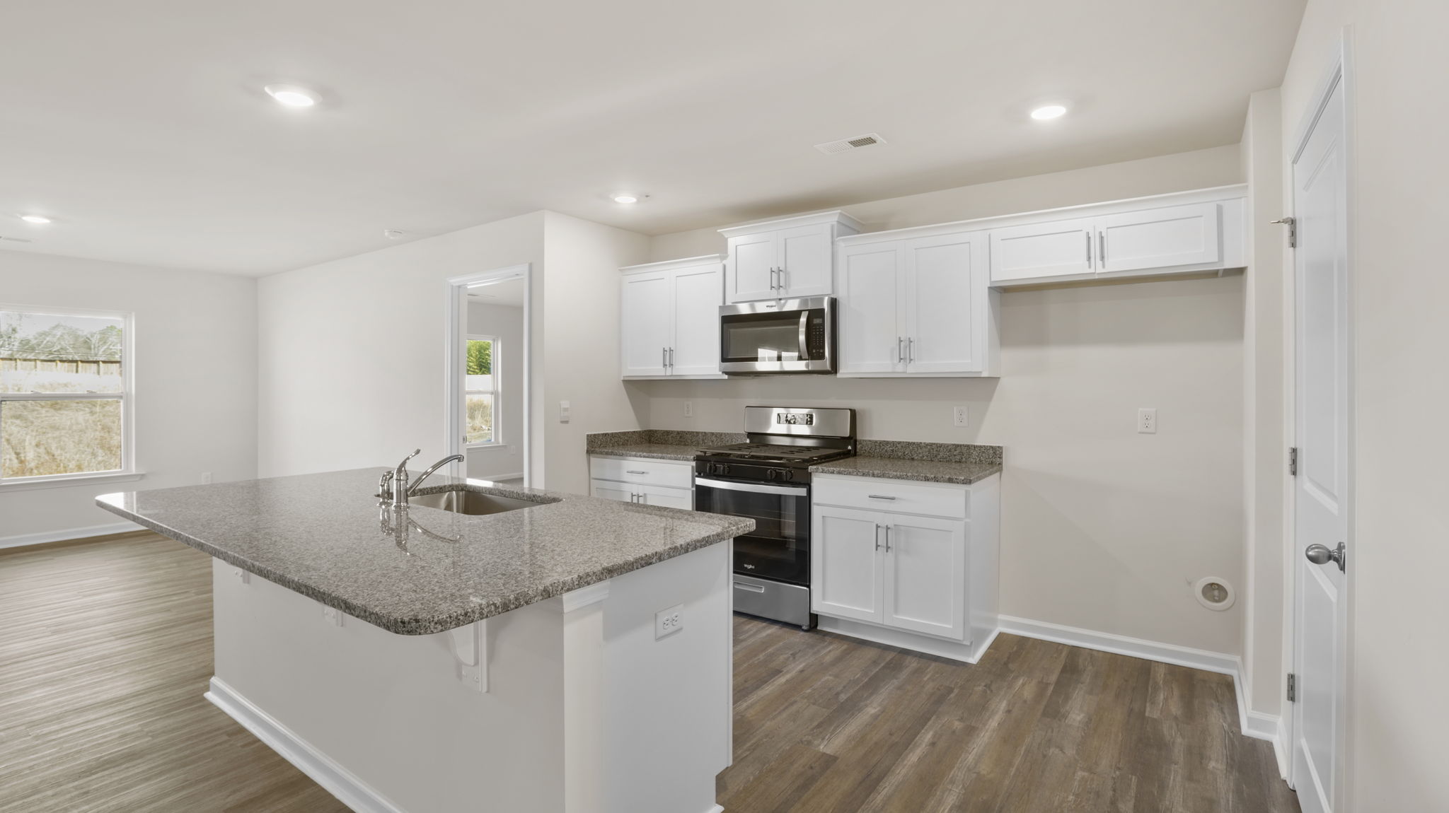 Kitchen and island have quartz countertops.