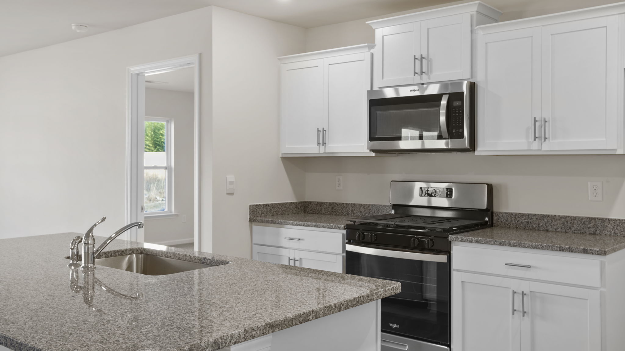 Kitchen features stainless steel appliances.