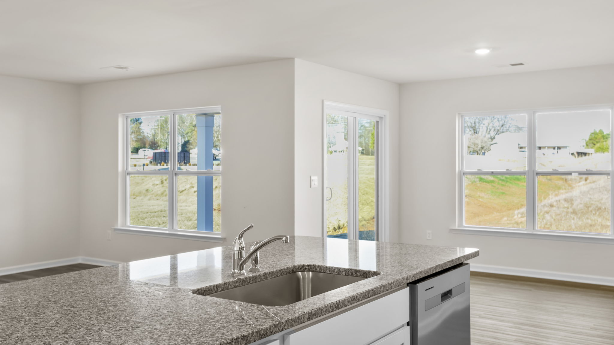 View from island of dining area and doors to the back yard.