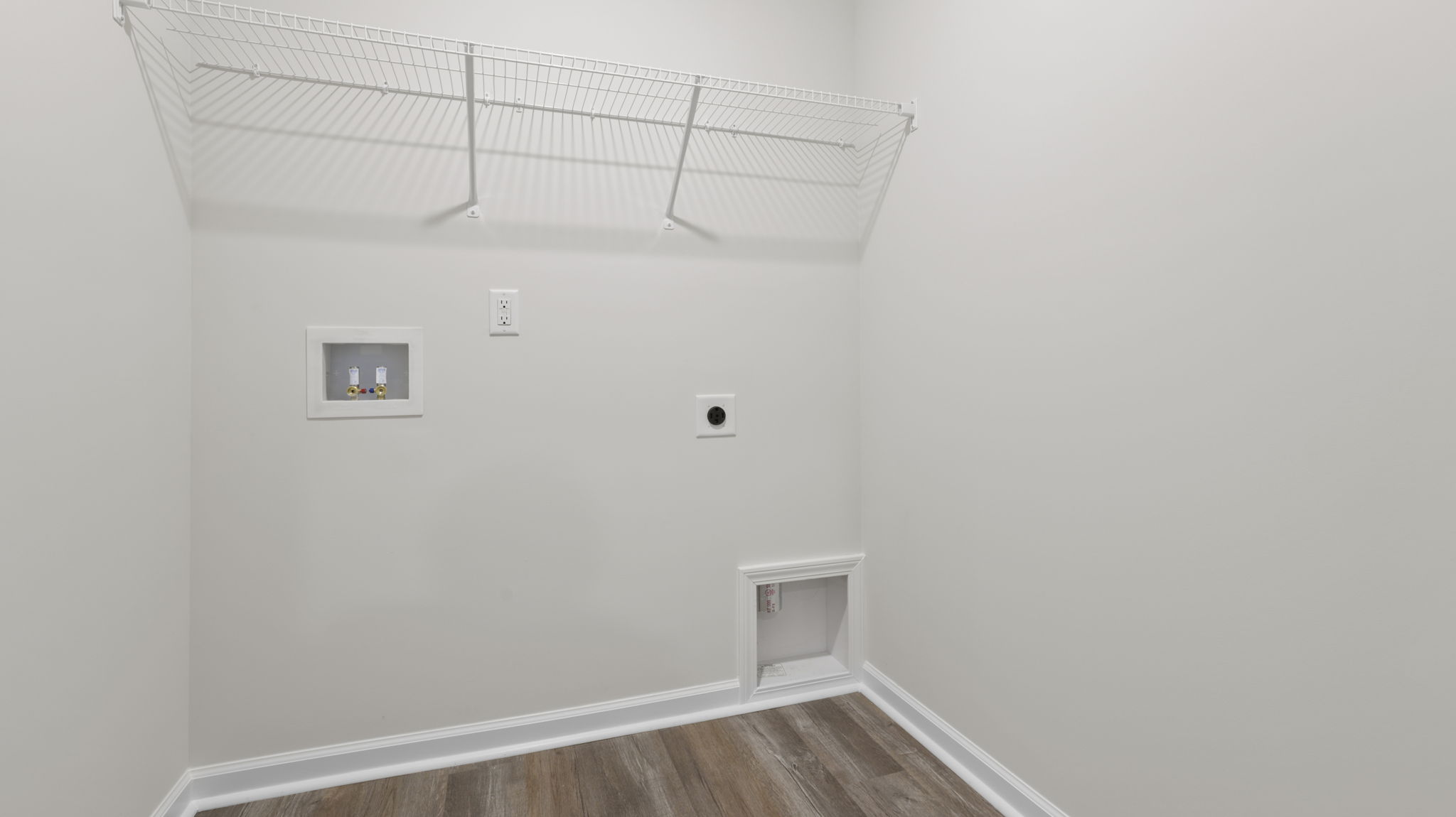 Walk-in laundry room with shelving.