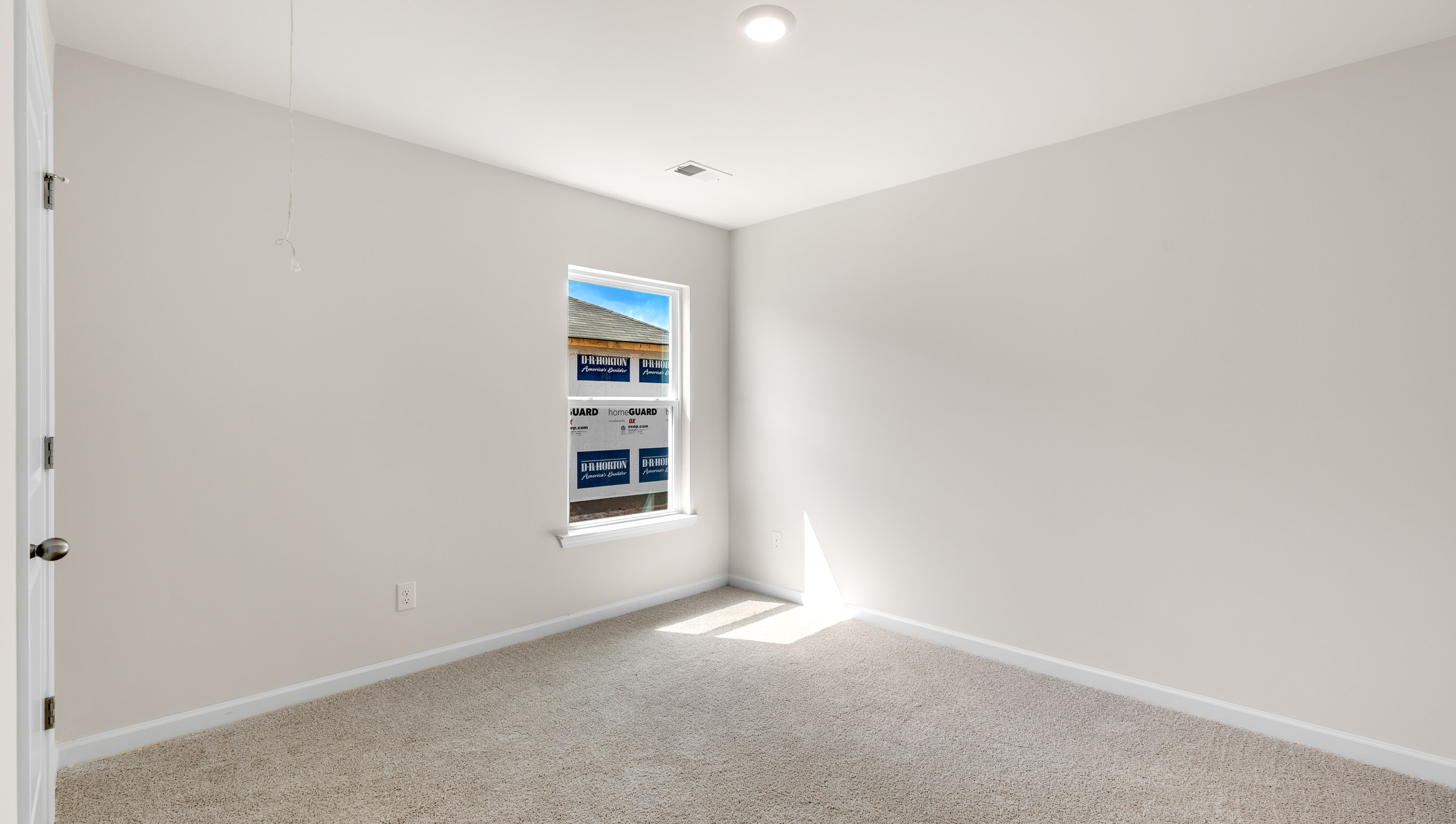Bedroom with window and carpet.