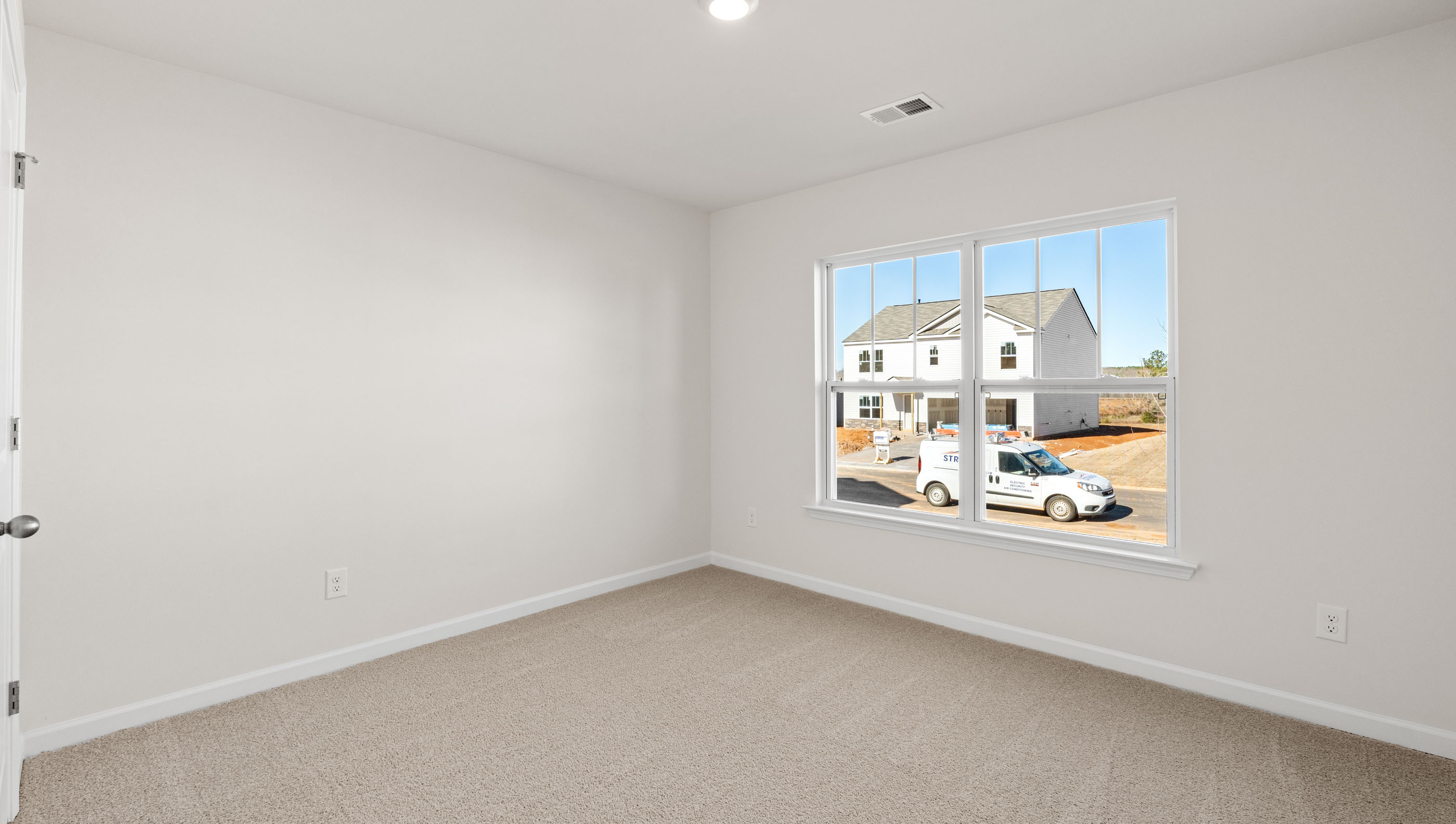 Bedroom with carpet and windows.