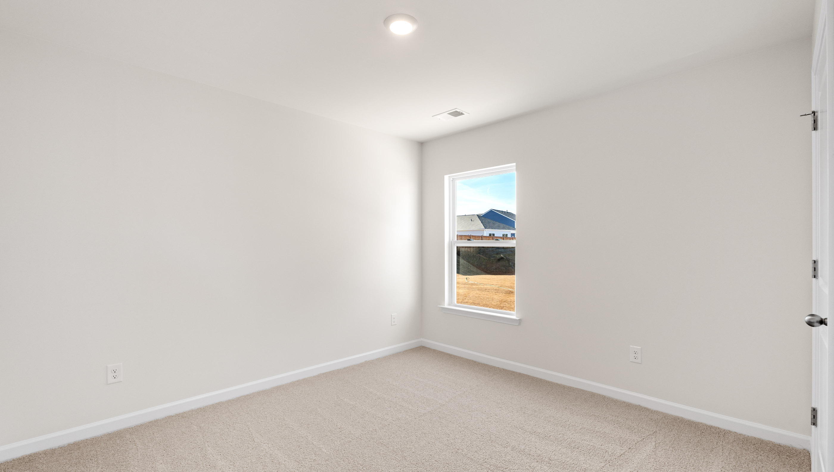 Bedroom with carpet and windows.