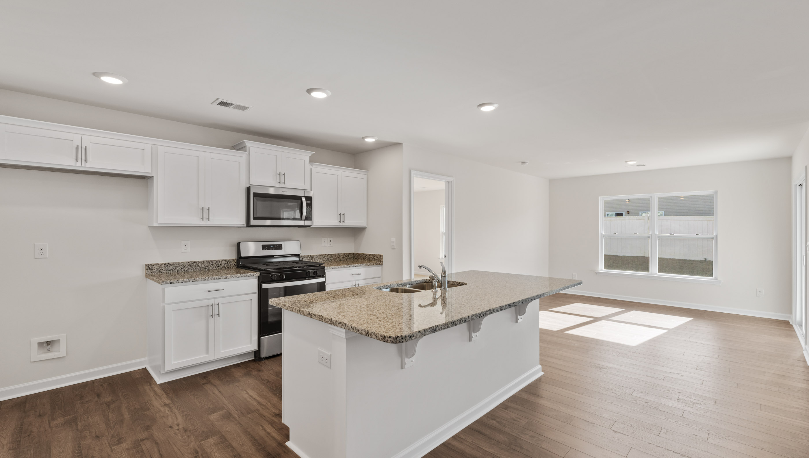 Kitchen with island and granite countertops.