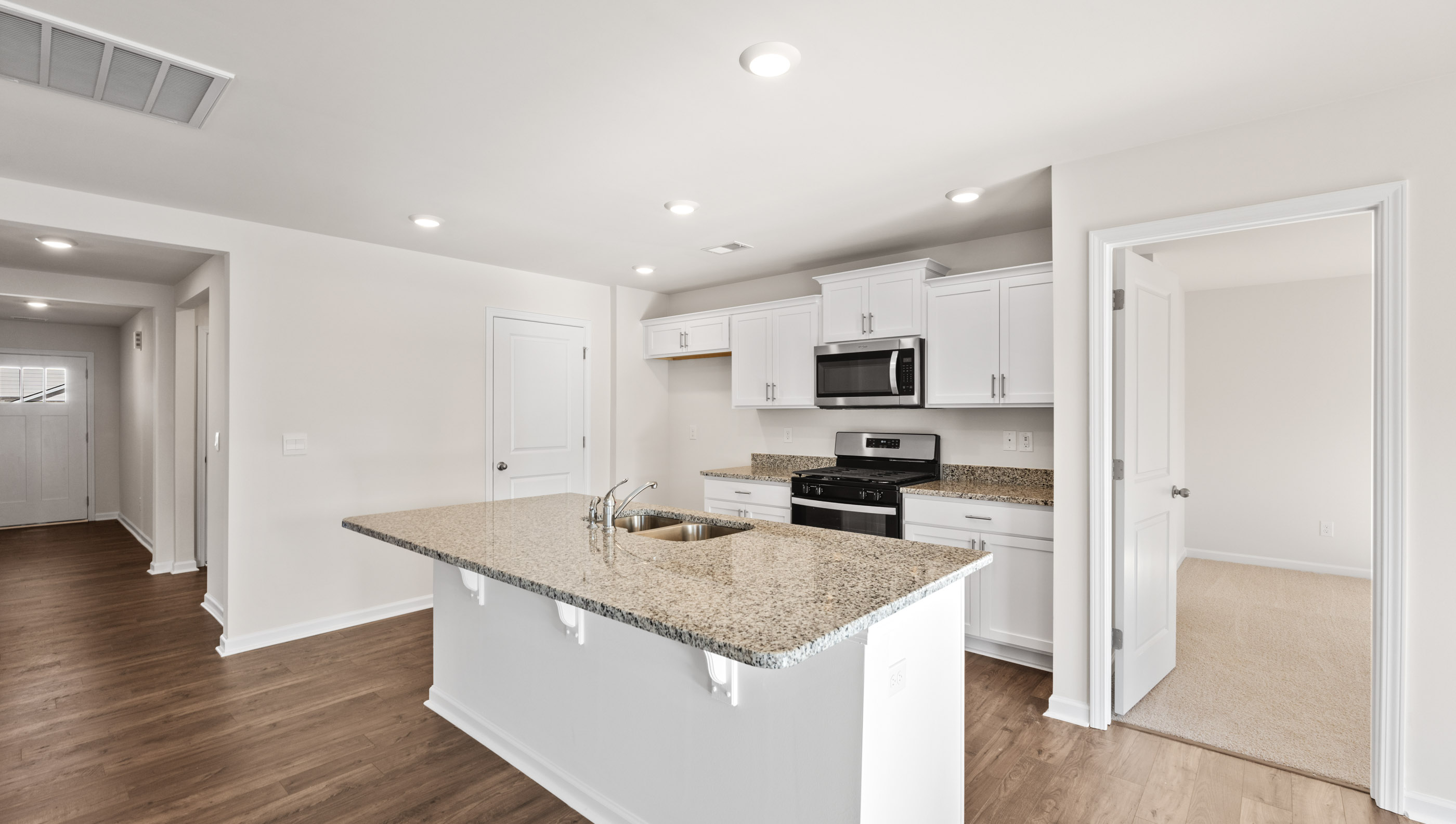 Kitchen with island and granite countertops.