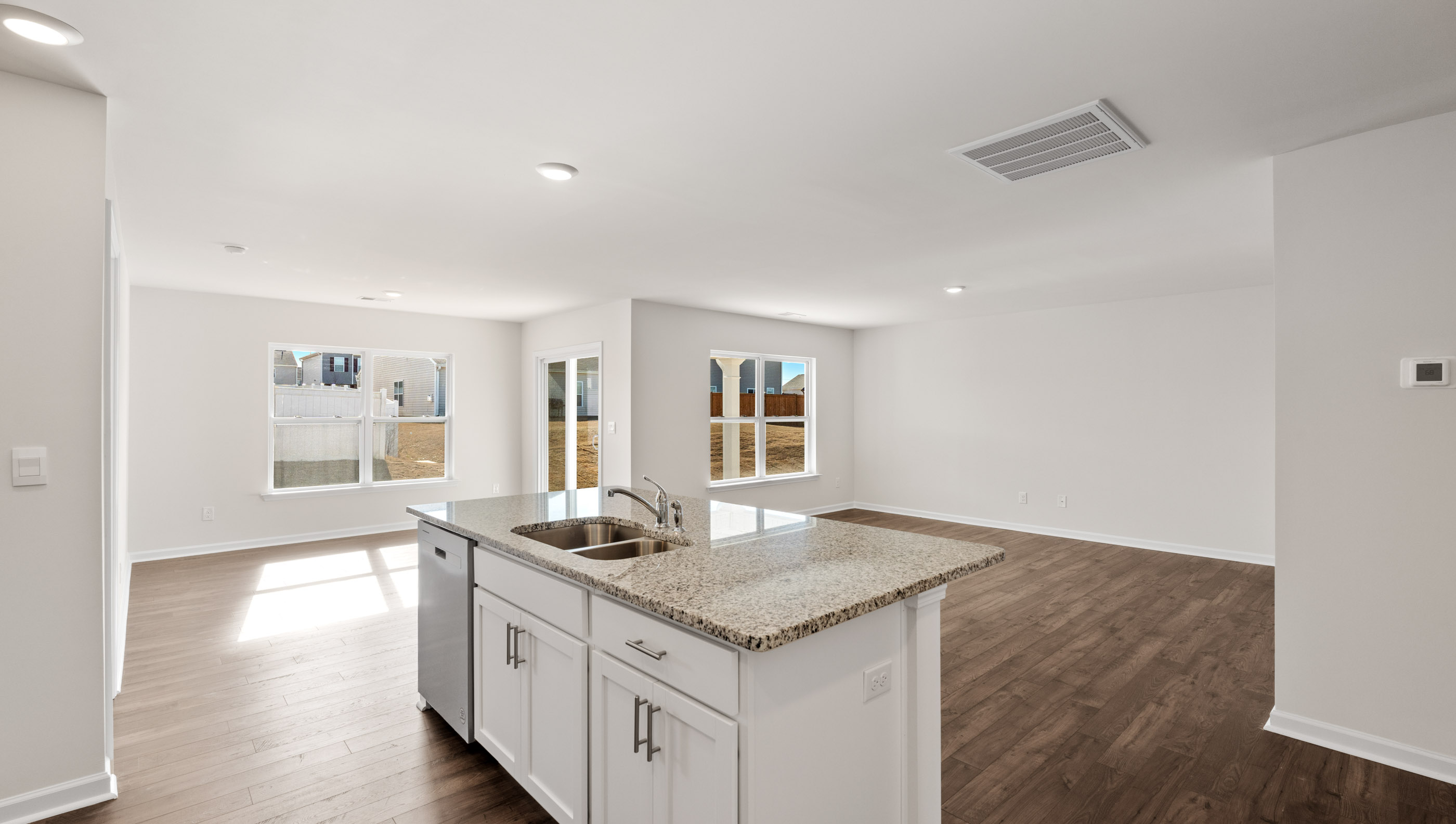 View from kitchen into dining and family rooms.
