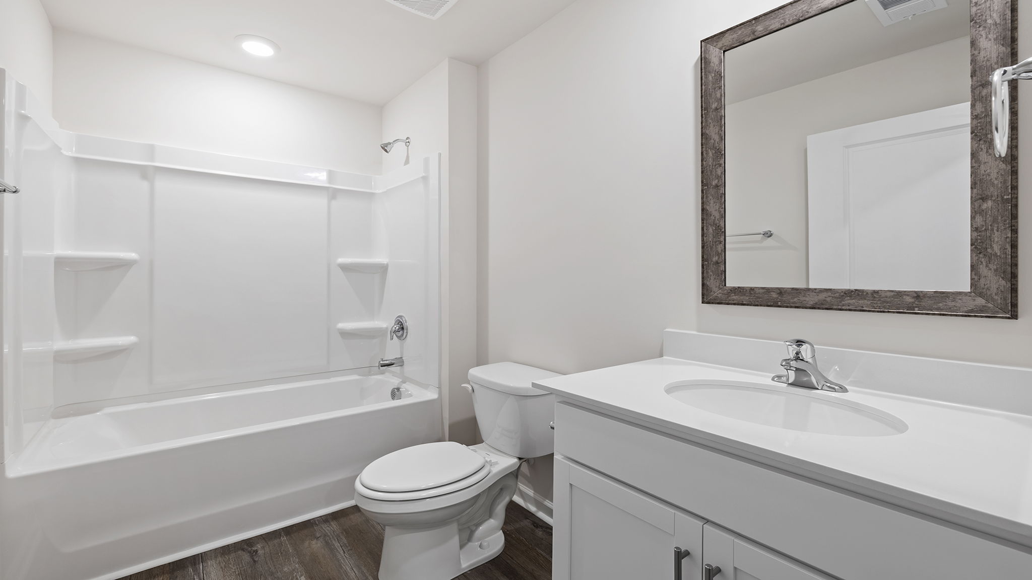 Hall bathroom with vanity and combination shower / tub.
