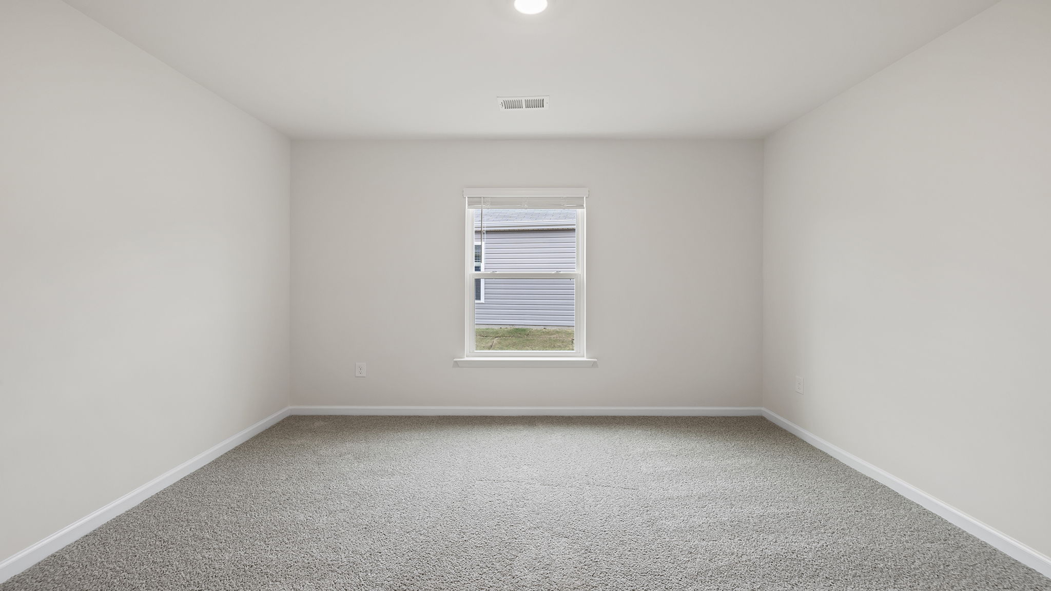 Bedroom with window and carpet.