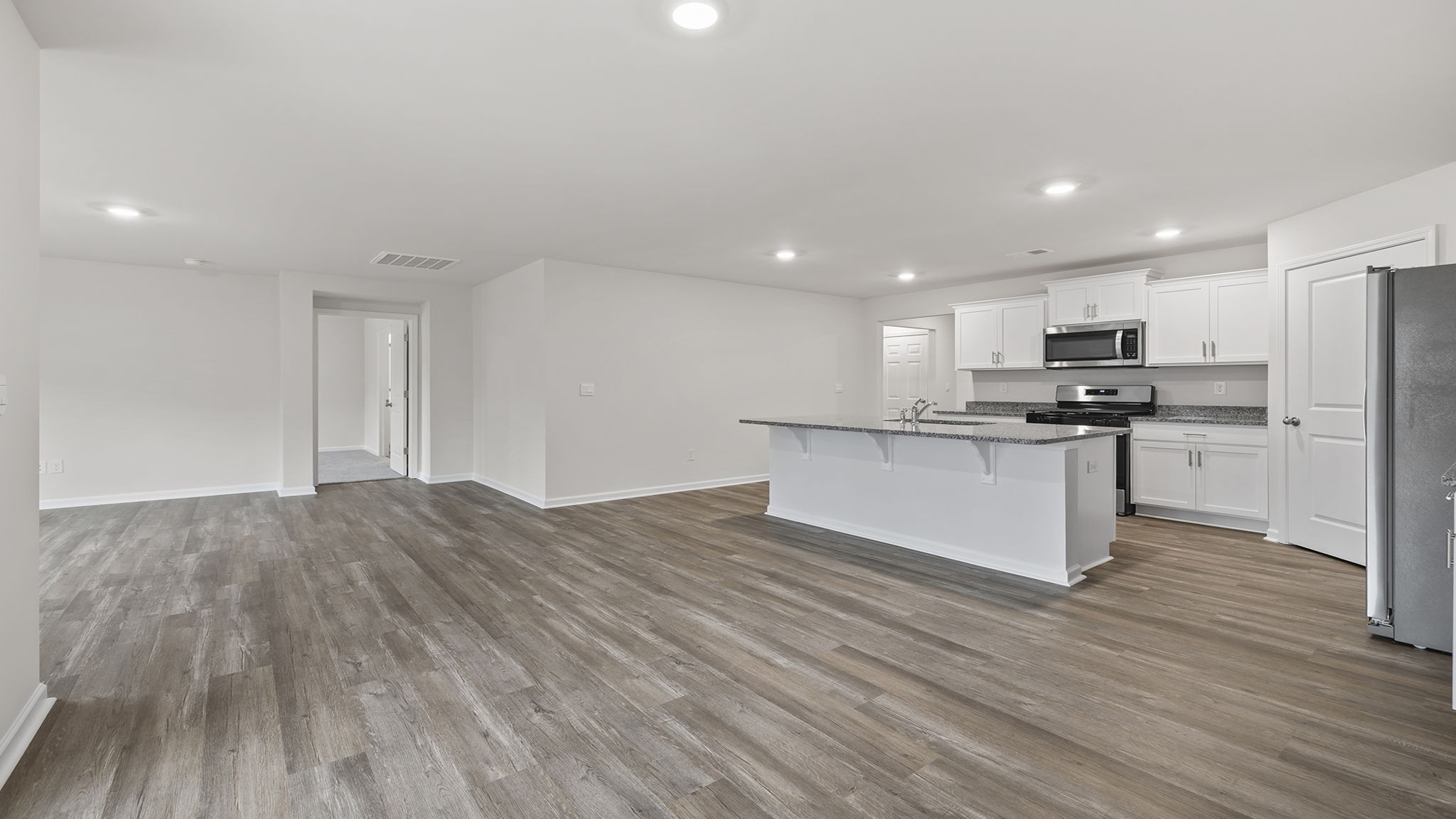 View of kitchen and hallway from the dining area.