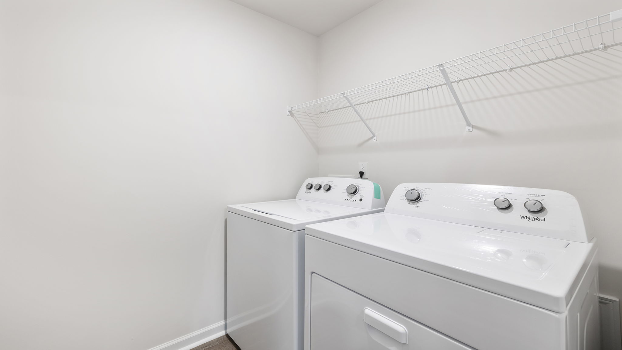 Walk-in laundry room with shelving.