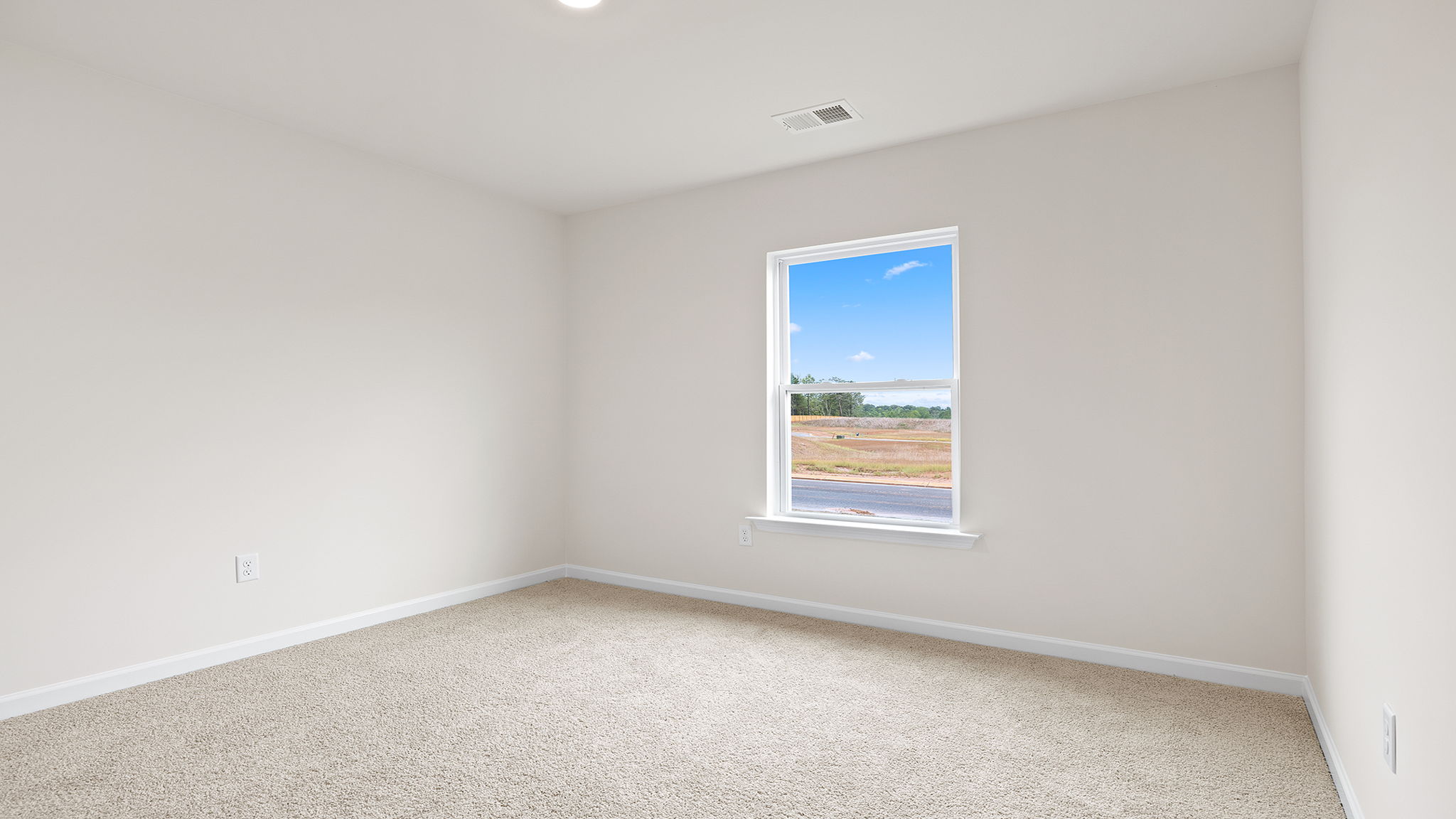 Bedroom with window and carpet.