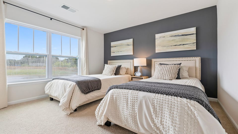 Bedroom with carpet and windows.