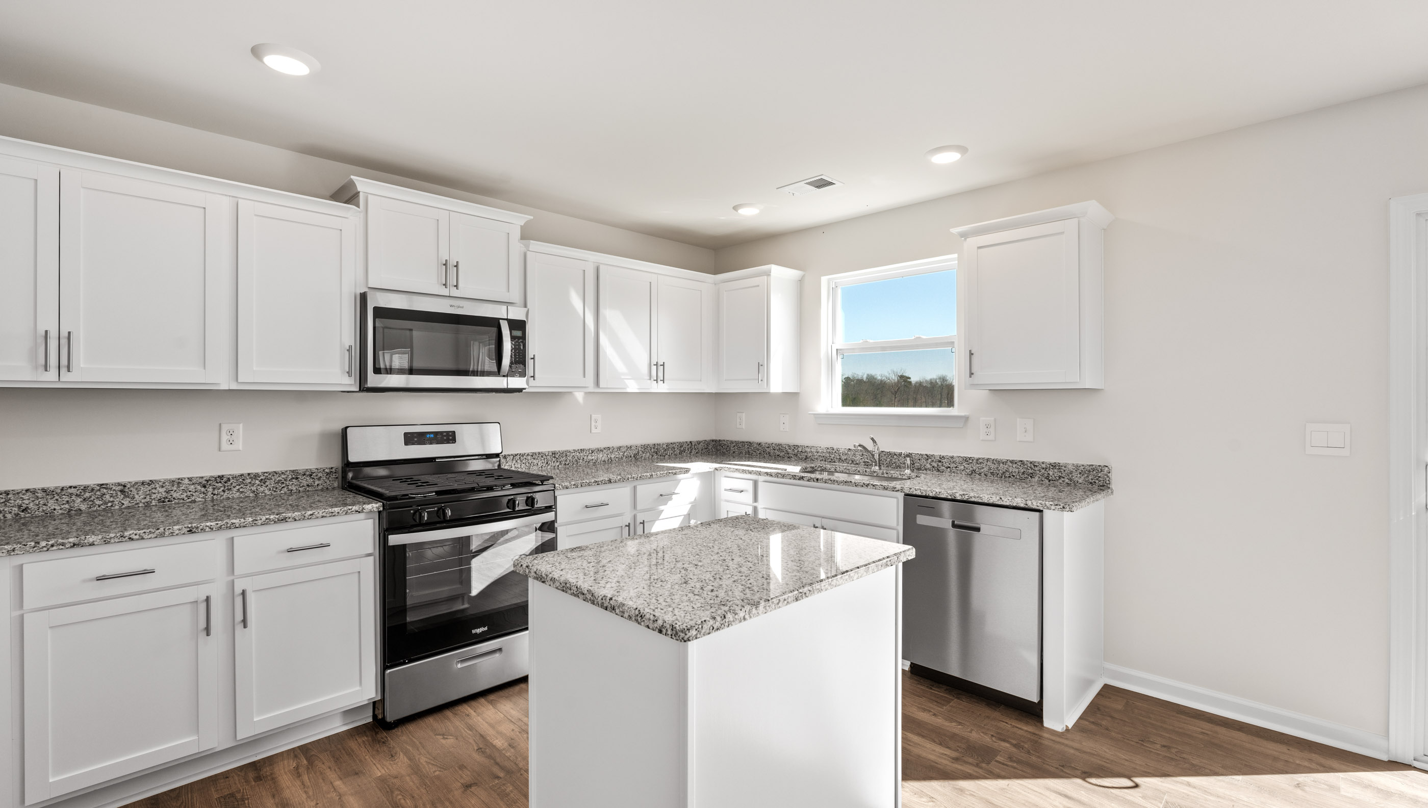 Kitchen and island with granite counter tops.