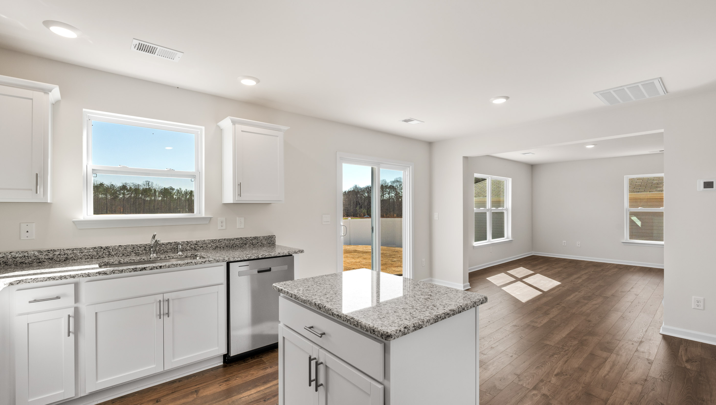 Kitchen and island with granite counter tops.