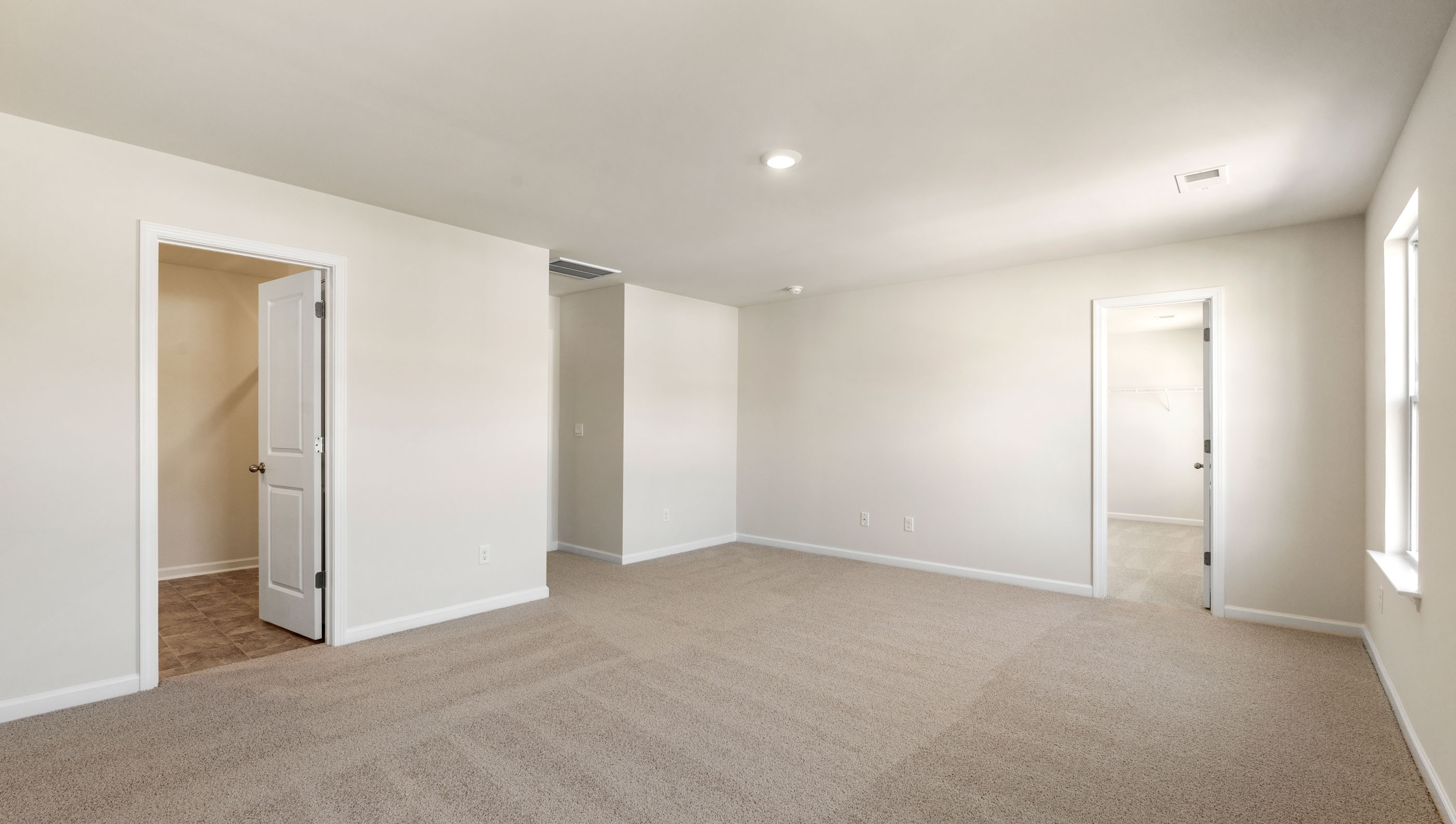 Bedroom with carpet and windows.