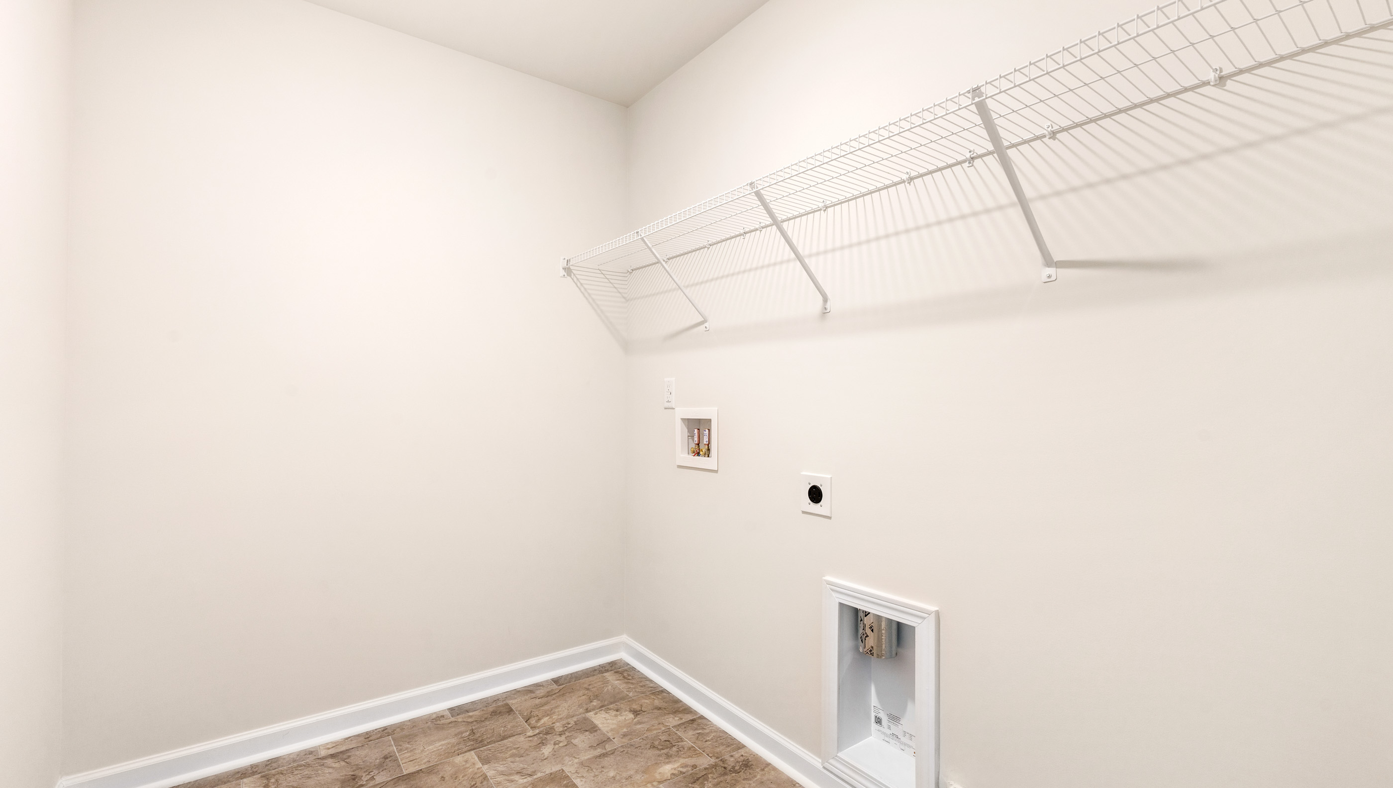 Laundry room with hanging shelves.
