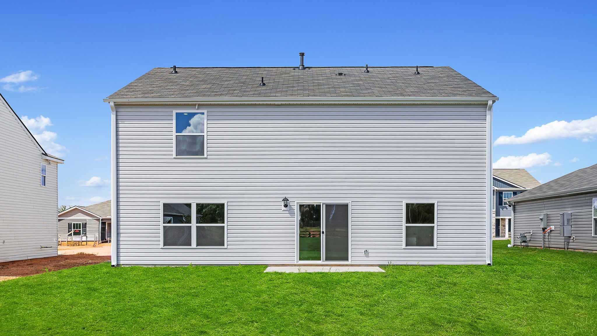 Exterior image of the Belhaven home with large backyard and patio.