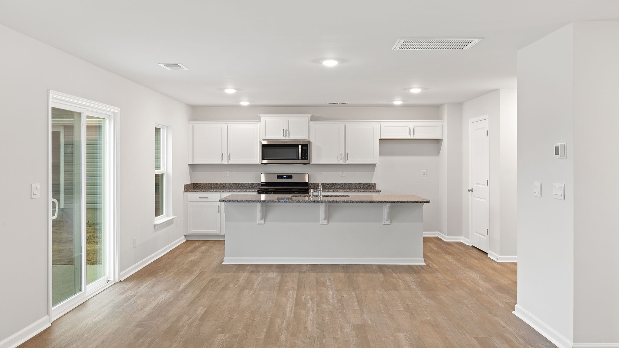 Kitchen and island have quartz countertops.