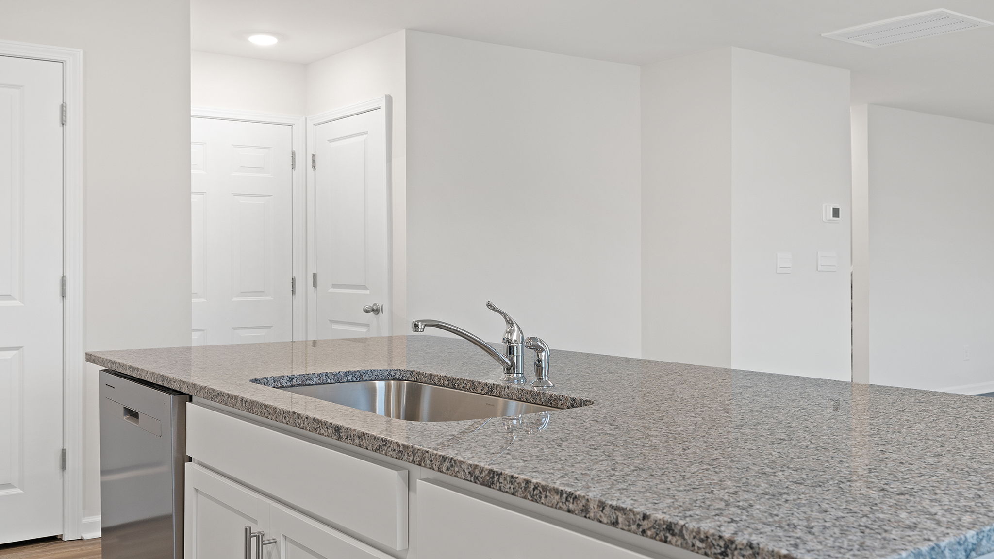 The island hosts the sink and dishwasher.