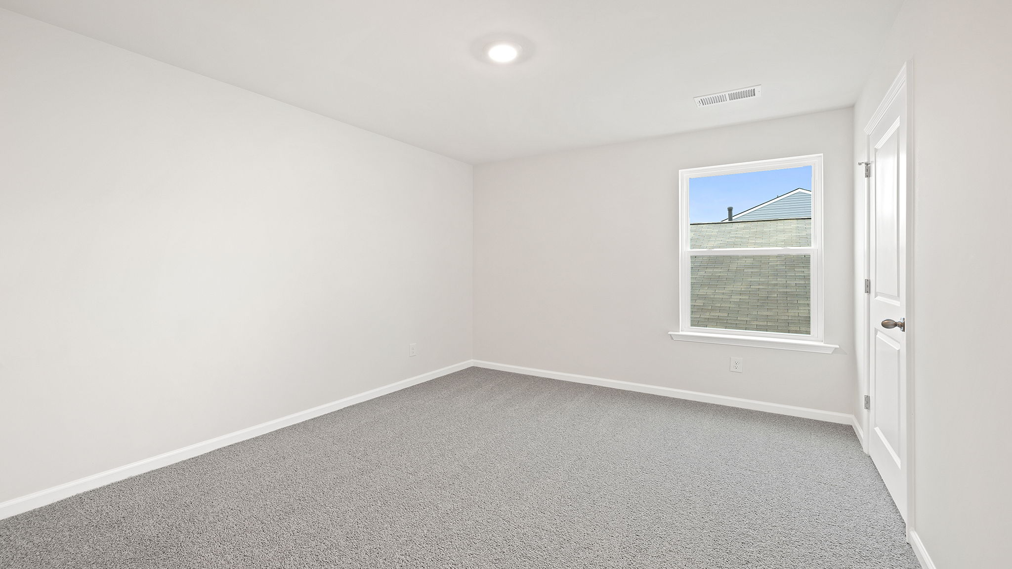 Bedroom with window and carpet.