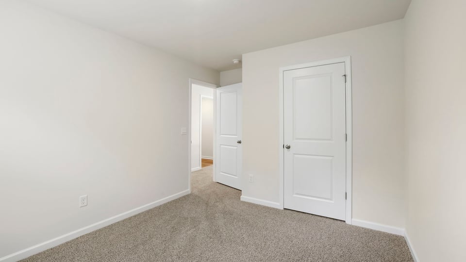 Bedroom with carpet and window.
