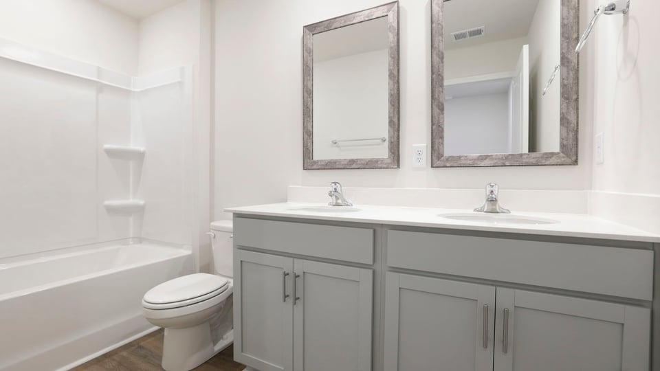 Bathroom with double vanity sink and bathtub.