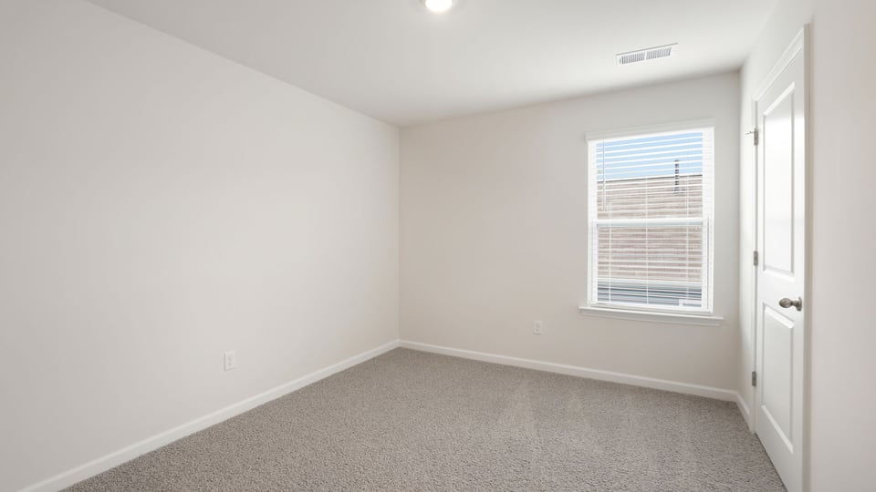 Bedroom with carpet and window.