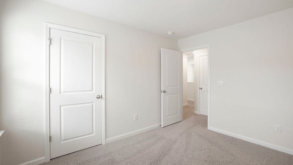 Bedroom with carpet and window.