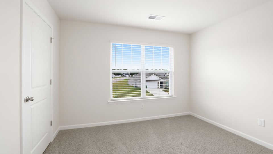 Bedroom with carpet and window.