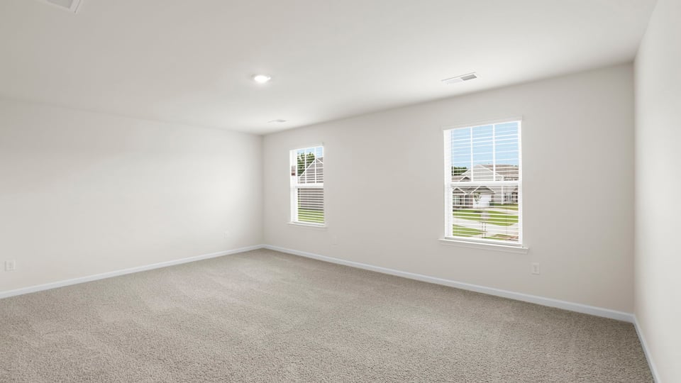 Bedroom with carpet and window.