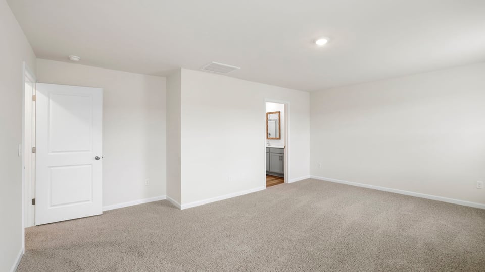 Bedroom with carpet and window.