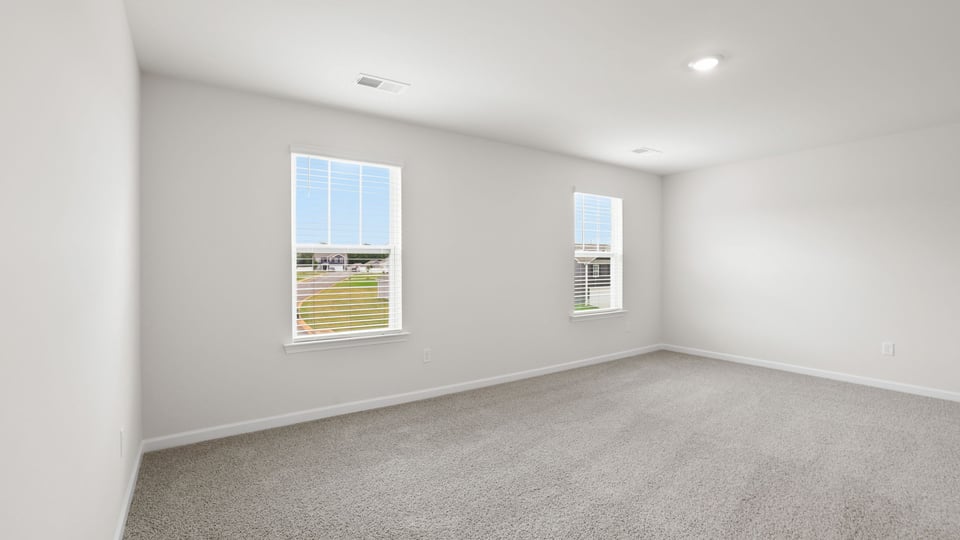 Bedroom with carpet and window.
