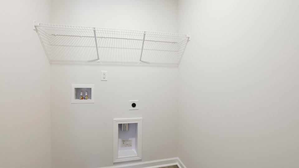 Laundry room with hanging storage racks.