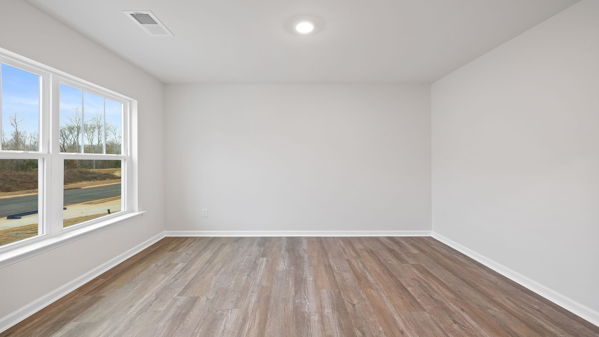 Study with large window and recessed lighting.