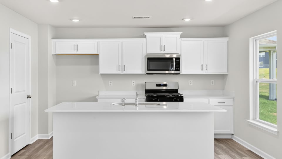 Kitchen with island and cabinets.