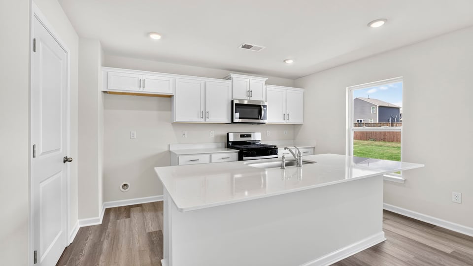 Kitchen with island and cabinets.
