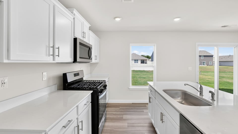 Kitchen with island and cabinets.