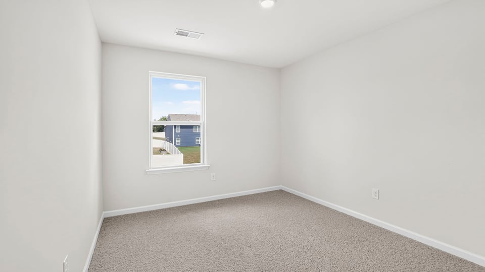 Bedroom with carpet and window.