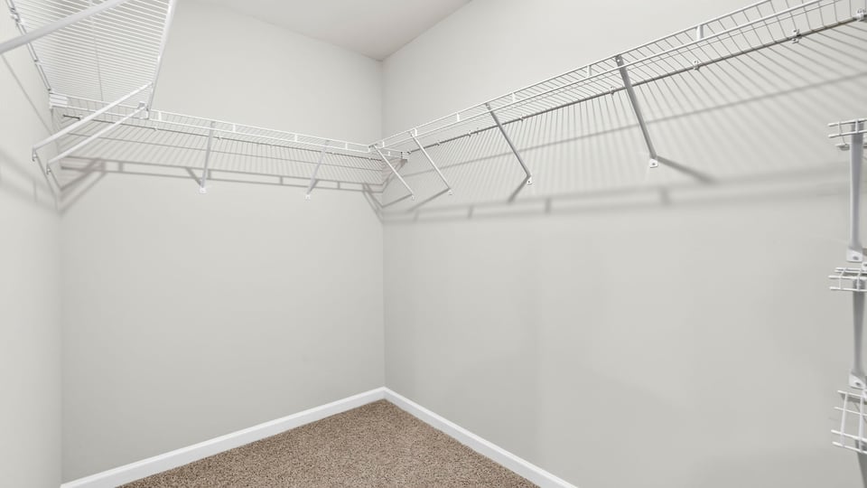 Primary closet with shelf.