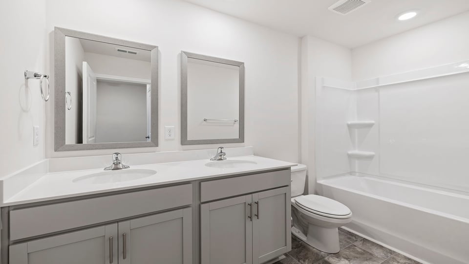 Hall bathroom with dual sink vanity.