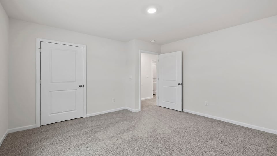 Bedroom with window and carpet.